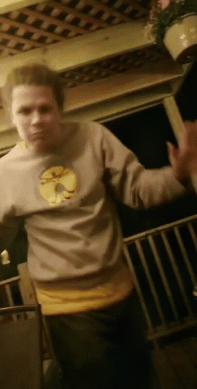 Man In Sweatshirt With Yellow Circle On Porch GIF