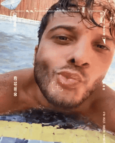 Man In Swimming Pool Being Recorded By Camera GIF
