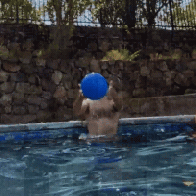 Man In Swimming Pool With Blue Ball GIF