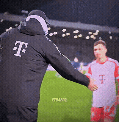 Man In T-Mobile Jacket Talks To Soccer Player GIF