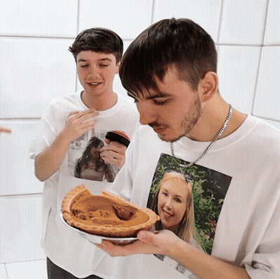 Man In T-Shirt With Woman Holding Pie GIF