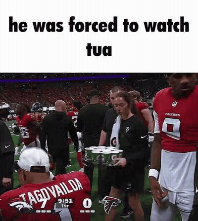 Man In Tagovaildia Jersey Escorted By Woman With Gatorade Tray GIF