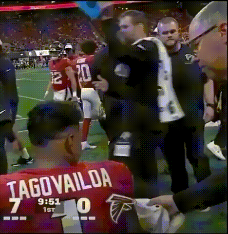Man In Tagovailoa Jersey Helped By Man In Suit GIF