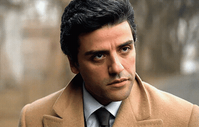 Man In Tan Coat And Tie Looks Serious GIF