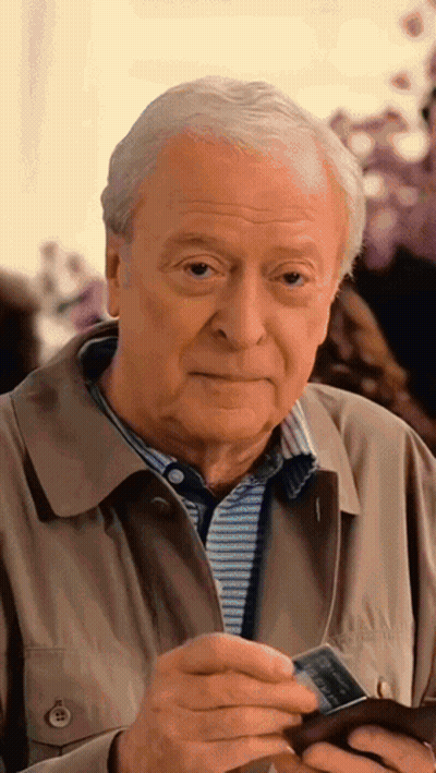 Man In Tan Jacket Holding Visa Card GIF