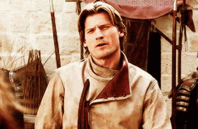 Man In Tan Jacket Red Collar Looking At Camera GIF