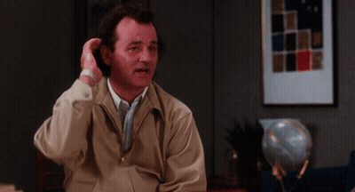 Man In Tan Jacket Sitting At Table GIF