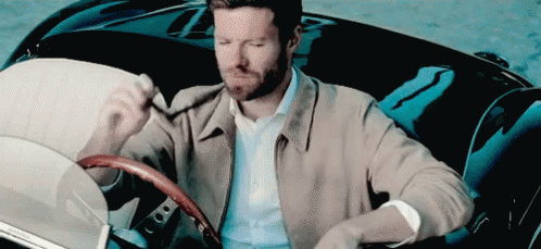 Man In Tan Jacket Sitting In Black Car GIF