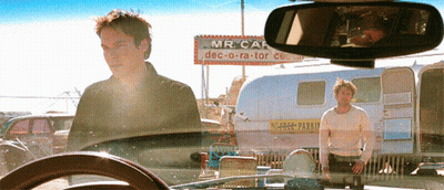 Man In Tan Jacket Smiling Looking Aside GIF