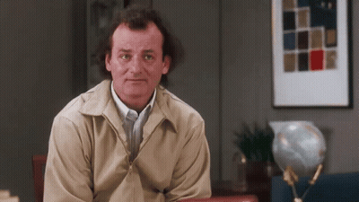 Man In Tan Jacket With Globe GIF
