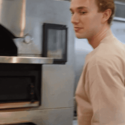 Man In Tan Shirt In Front Of Microwave GIF