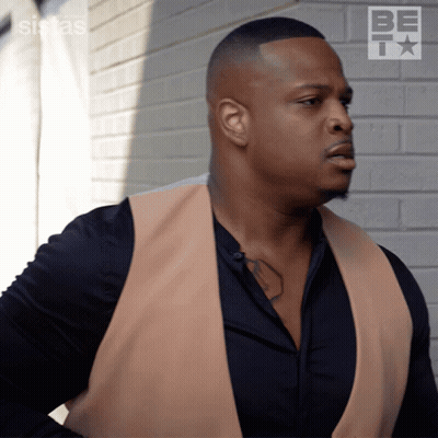 Man In Tan Vest At Brick Wall BET GIF