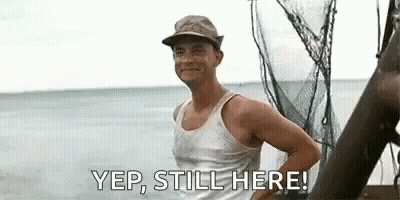Man In Tank Top And Hat Standing On Boat GIF
