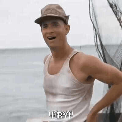 Man In Tank Top And Hat Standing On Boat GIF