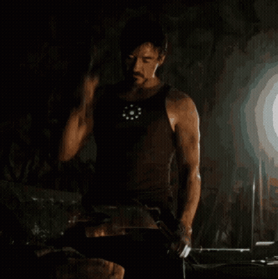Man In Tank Top Holding Hammer GIF