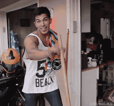 Man In Tank Top Holding Skateboard GIF