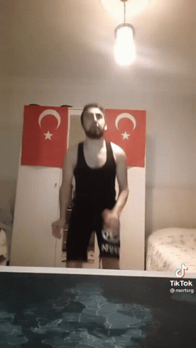 Man In Tank Top Jumping Into Pool GIF