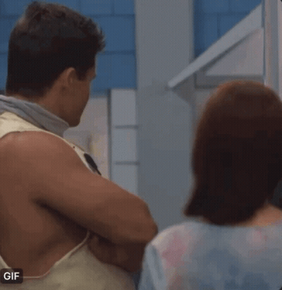 Man In Tank Top Next To Woman GIF