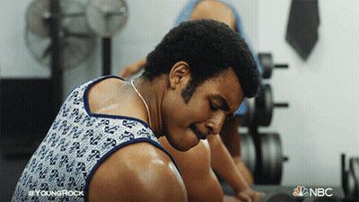 Man In Tank Top Sweating In Gym With NBC Logo GIF