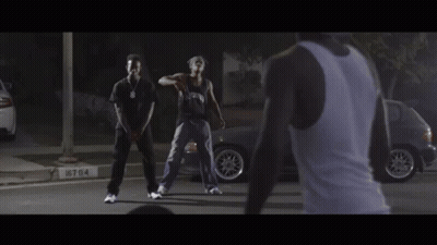 Man In Tank Top Watching Two Men Dancing GIF