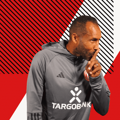 Man in Targobank Sweatshirt Shushing