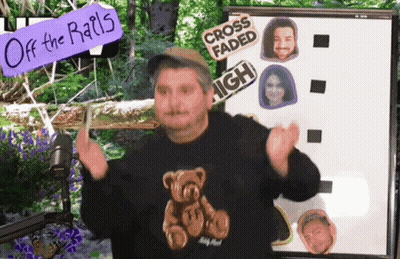 Man In Teddy Bear Sweater In Front Of Off The Rails Board GIF