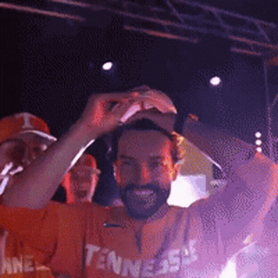 Man In Tennessee Shirt Holding Hat Up GIF