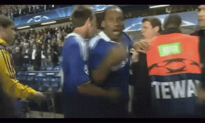 Man In Tewa Vest In Crowd GIF