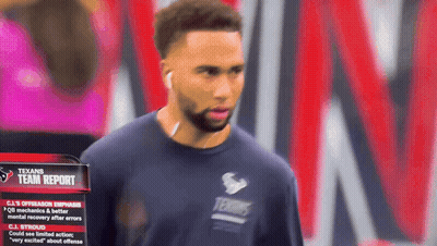 Man In Texans Shirt Standing By Team Report Sign GIF