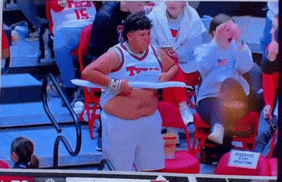 Man In Texas Jersey Holding Towel Over Stomach GIF