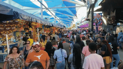 Man In Texas Shirt Walking Through Crowd GIF