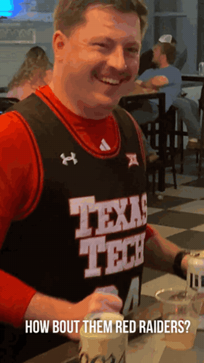 Man In Texas Tech Jersey Sitting At Table GIF
