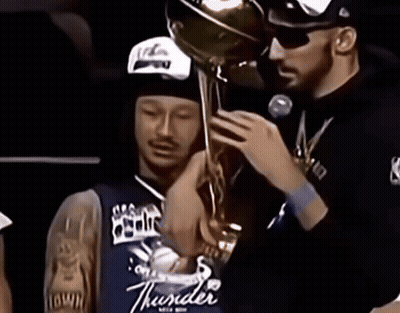 Man In Thunder Jersey Holding Trophy Over Another Man GIF