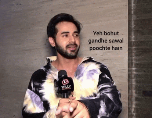 Man In Tie Dye Shirt Holding Telly Reporter GIF