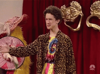 Man In Tie Dye Shirt In Front Of Red Curtain NBC GIF
