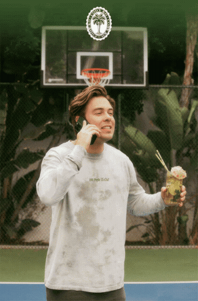 Man In Tie Dye Shirt Talking On Cell Phone GIF