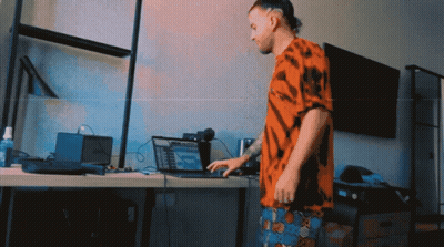 Man In Tie Dye Shirt Using Laptop GIF