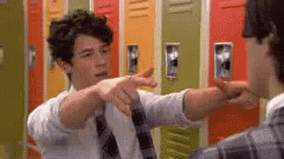 Man In Tie Pointing At Another Man By Lockers GIF