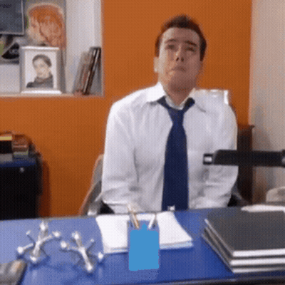 Man In Tie Sits At Desk GIF