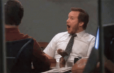 Man In Tie Sitting At Desk With Mouth Open GIF
