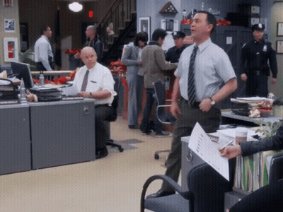 Man In Tie Standing In Front Of Emergency Sign GIF