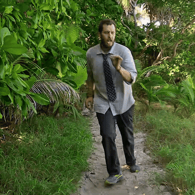 Man In Tie Walking Down Dirt Path GIF