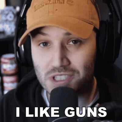 Man in Timberland Hat and Headphones Says I Like Guns