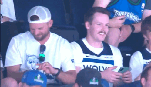 Man In Timberwolves Jersey Sitting GIF