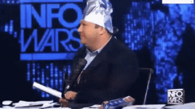 Man In Tin Foil Hat In Front Of InfoWars Sign GIF