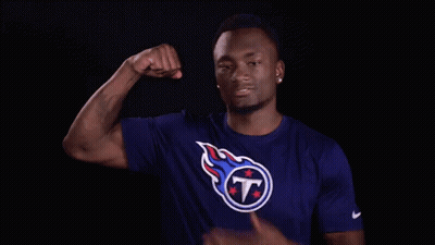 Man In Titans Shirt Flexing Arm GIF