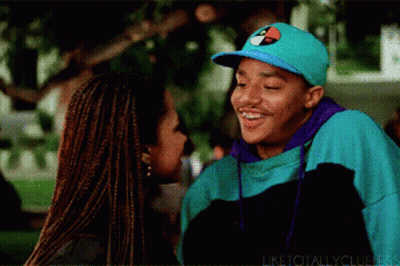 Man In Tommy Hilfiger Hat Smiling Next To Woman GIF