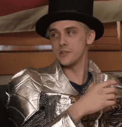 Man In Top Hat And Armor Holding Drink GIF