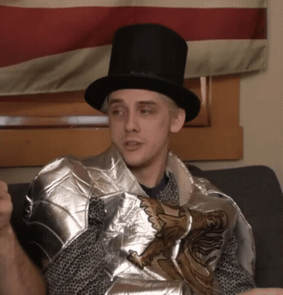 Man In Top Hat And Knight's Armor Sitting On Couch GIF