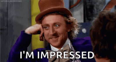 Man In Top Hat And Purple Jacket Talking To Another Man GIF